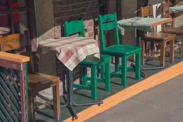 Tables and chairs of a street cafe in a vintage style