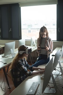 Women using virtual reality headset and digital tablet