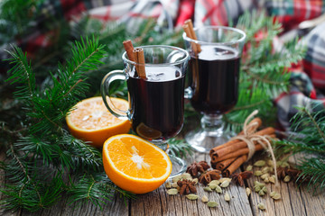 Homemade winter mulled wine with ingredients on table