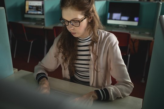 Woman working on computer in college