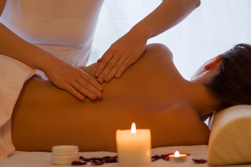 Fototapeta na wymiar Back massage woman enjoying massage indoors - close up