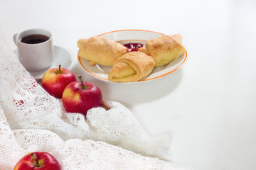 delicious apples, cup of coffee, croissant on the white wooden background