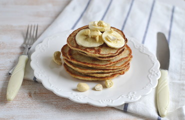 Homemade Banana Cashew Pancakes Honey Sauce Milk Flour Wooden Table Kitchen Towel Cutlery 