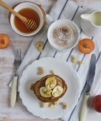 Homemade Banana Cashew Pancakes Honey Sauce Milk Flour Wooden Table Kitchen Towel Cutlery 