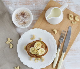 Homemade Banana Cashew Pancakes Honey Sauce Milk Flour Wooden Table Kitchen Towel Cutlery 