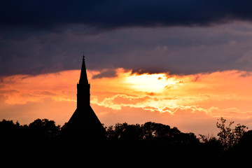 Sunset silhouette of church tower at sunset