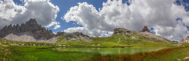 Fototapeta na wymiar Mountain panorama of the Paternkofel, Sextner Stone, Toblinger Knot and the Three Peaks hut, viewed from the Böden Lakes in the Dolomites