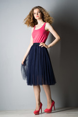 Fototapeta premium Young beautiful woman in pink shoes