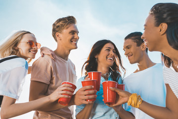 friends clinking plastic glasses