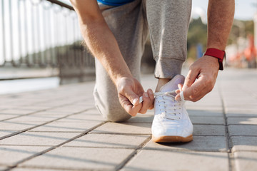 Close up of male hands tying shoelaces