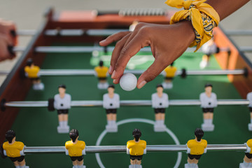 woman holding ball for table football