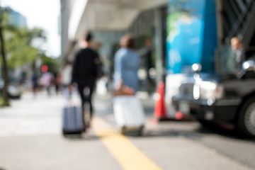 People with Suitcases Walking in Holiday at the City of Nagoya in Japan; Blur Background with Bokeh Effects
