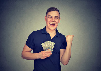 Happy man with money isolated on gray background
