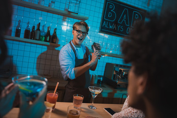 barmen making alcohol cocktail