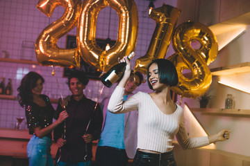 african american woman with bottle of champagne