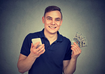 Happy man with mobile phone and money