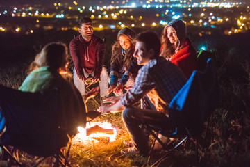 The smile people hold hands near the bonfire. night time