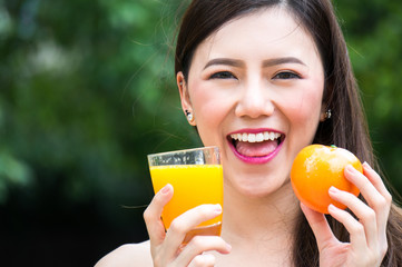 Asian beauty woman hold fruit and vegetable for healthy on grass with smile