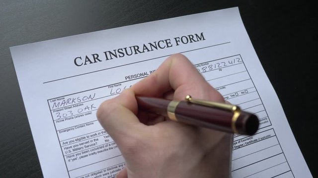 Car insurance form being filled, closeup. This form is randomly filled with no real names or numbers.