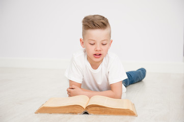 Young boy is reading a book