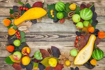 Autumn background from fruit, leaves and berries. Peaches, apples, pumpkins, berries. Autumn still life on a wooden table. Top view. Horizontal texture of tree. Copy space