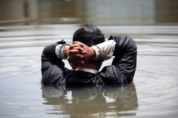 businessman was arrested by handcuffs and drowning in water with copyspace.