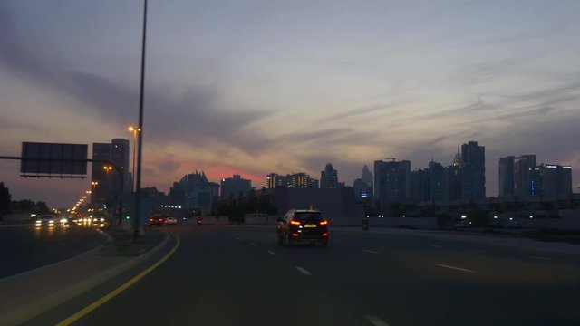 sunset sky dubai city al barsha traffic street pov car driving panorama 4k uae
