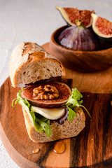 Fig and goat cheese bruschetta with rocket salad.Fig and goat cheese bruschetta with rocket salad. Sandwich with fig. 