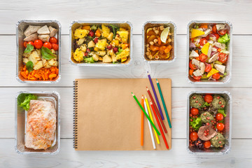 Healthy food take away in boxes, top view at wood