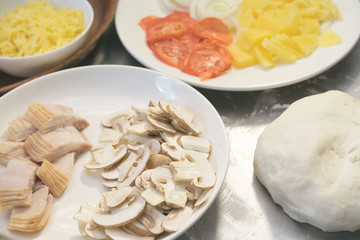 Homemade pizza with ham, mushrooms, mozzarella, tomato sauce and capers, italian food
