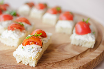 Canape with cottage cheese, basil and tomato