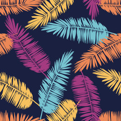Seamless floral pattern with stylized palm leaves. Jungle foliage, tropical hues on navy blue background. Textile design.