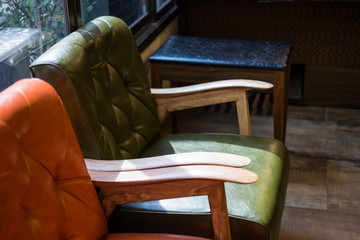 Luxury leather sofa in living room interior and morning sunlight from window. Concept old vintage style living room.