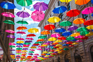 Fototapeta na wymiar Street decorated with colored umbrellas