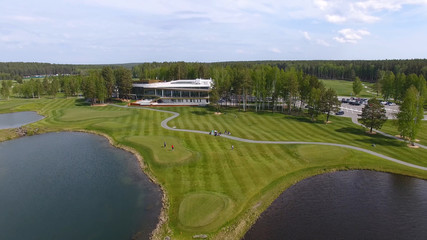 Golf course on a Sunny day, an excellent Golf club with ponds and green grass, view from the sky
