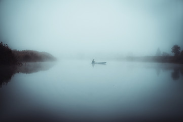 A lonely fishing boat in the fog