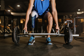 Fototapeta na wymiar Disabled young man training in the gym.