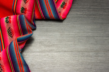 Color pattern tablecloth on wooden table for background. Fabric texture. Wooden texture.Template...