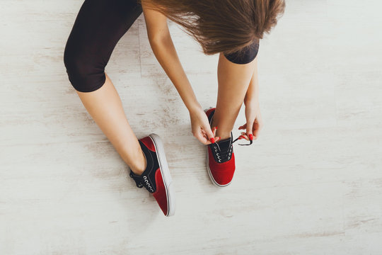 Woman Tying Up Lace On Sport Shoes Top View