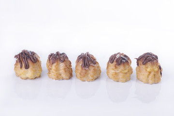 Chocolate cream puff isolated on white background.