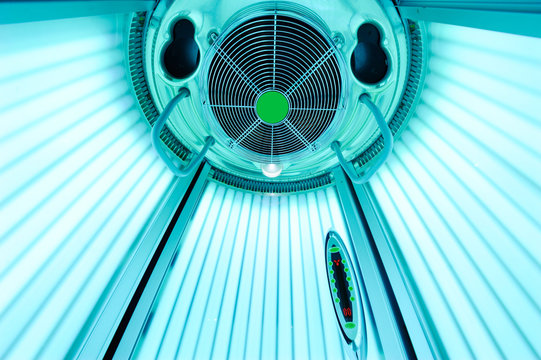 An empty solarium for sunbathing in a beauty salon or a spa with included ultraviolet lamps