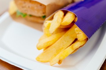 Fried french fries with burger outdoors