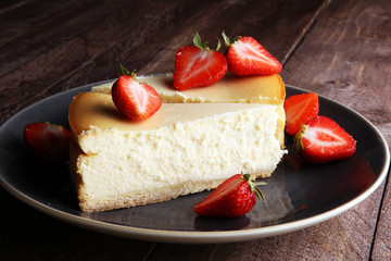 Homemade cheesecake with fresh strawberries and mint for dessert - healthy organic summer dessert pie cheesecake. Vanilla Cheese Cake.