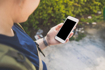asian girl tourists woman holding phone using  gadget smart phone looking map  in website to travel tourist area with people connection that life fun