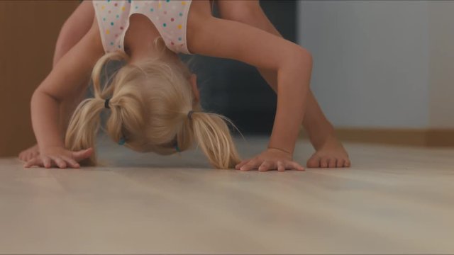Cute little girl playing with RC off-road truck car (radio-controlled) at home. Shallow DOF. 4K UHD 60 FPS
