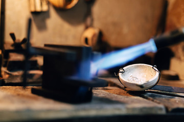 Obraz na płótnie Canvas Jeweler using tourch to heat welding tools
