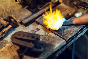 Jeweler melting gold