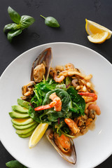 Warm salad with grilled seafood flat lay