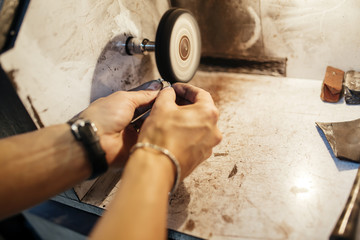 Jeweler polishing jewelry