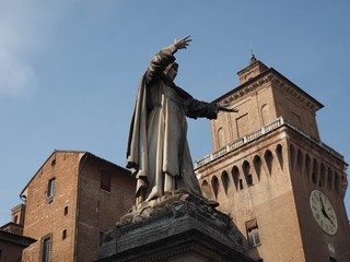 Statue of Savonarola and castle of Ferrara, Italy.